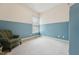 Well-lit bedroom with a chair near the window and two-tone walls at 7 Teahouse Ct, Durham, NC 27707