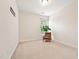 This bedroom has carpet, one window and one chair with a plant at 7 Teahouse Ct, Durham, NC 27707