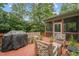 Inviting deck featuring comfortable seating and a grill, adjacent to a screened-in porch at 7 Teahouse Ct, Durham, NC 27707