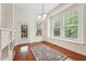 Bright dining area with large windows, door to the outside deck, and a decorative rug at 7 Teahouse Ct, Durham, NC 27707
