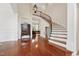 Grand foyer features wood floors, elegant curved staircase, and high ceilings, creating a welcoming entrance at 7 Teahouse Ct, Durham, NC 27707