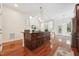 Open concept kitchen features granite counters, stainless appliances, and an eat-in island at 7 Teahouse Ct, Durham, NC 27707