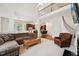 Spacious living room with soaring ceilings, fireplace, and open layout connecting to kitchen and upper level at 7 Teahouse Ct, Durham, NC 27707