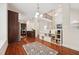 Open concept living room featuring hardwood floors, a kitchen, and a staircase to a second level at 7 Teahouse Ct, Durham, NC 27707