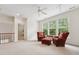 Spacious, carpeted living room with many windows and two arm chairs at 7 Teahouse Ct, Durham, NC 27707