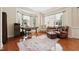 A home office with hardwood floors, natural light, and comfortable leather seating at 7 Teahouse Ct, Durham, NC 27707