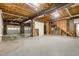 Unfinished basement with open ceiling, cement flooring and garage doors at 7604 Copper Creek Ct, Wake Forest, NC 27587