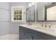 Bathroom featuring a double vanity, stylish mirrors, and neutral paint at 7604 Copper Creek Ct, Wake Forest, NC 27587
