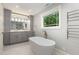 Modern bathroom with soaking tub, dual vanity, and stylish fixtures at 7604 Copper Creek Ct, Wake Forest, NC 27587