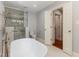 Luxurious bathroom with soaking tub, walk-in shower, and modern design at 7604 Copper Creek Ct, Wake Forest, NC 27587