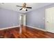 This bedroom showcases beautiful hardwood floors, a ceiling fan, and a doorway at 7604 Copper Creek Ct, Wake Forest, NC 27587