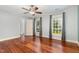 Light-filled bedroom with hardwood floors, ceiling fan, and bright windows at 7604 Copper Creek Ct, Wake Forest, NC 27587