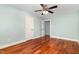 Bright bedroom featuring hardwood floors, ceiling fan, and white doors at 7604 Copper Creek Ct, Wake Forest, NC 27587
