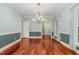 Formal dining room featuring hardwood floors and elegant chandelier at 7604 Copper Creek Ct, Wake Forest, NC 27587