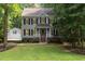 Two-story home with gray siding, black shutters, and a well-manicured lawn at 7604 Copper Creek Ct, Wake Forest, NC 27587