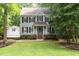 Two-story home with gray siding, black shutters, and a well-manicured lawn at 7604 Copper Creek Ct, Wake Forest, NC 27587