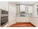 Classic white kitchen cabinets with granite countertops and stainless steel appliances at 7604 Copper Creek Ct, Wake Forest, NC 27587