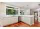 Well-lit kitchen featuring white cabinets, granite countertops, and stainless steel appliances at 7604 Copper Creek Ct, Wake Forest, NC 27587