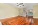 Open living room featuring hardwood floors, staircase, and view into kitchen at 7604 Copper Creek Ct, Wake Forest, NC 27587