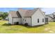 Exterior side view showcasing the home's vinyl siding, windows, and outdoor amenities at 80 Shallow Falls Ln, Benson, NC 27504