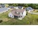 A well-maintained, two-story home featuring a screened-in porch and a backyard with lush green grass at 80 Shallow Falls Ln, Benson, NC 27504