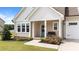 Charming front porch with a bench, floral accents, and a decorative wreath on the light blue door at 80 Shallow Falls Ln, Benson, NC 27504