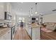 Open concept kitchen with island, granite countertops, stainless steel appliances, and adjacent dining area at 80 Shallow Falls Ln, Benson, NC 27504