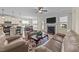 Open-concept living room flows to kitchen with fireplace and backyard access at 80 Shallow Falls Ln, Benson, NC 27504