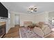 Neutral living room with fireplace, ceiling fan, and plush seating at 80 Shallow Falls Ln, Benson, NC 27504