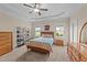 Spacious main bedroom with a tray ceiling, ceiling fan, and large windows at 80 Shallow Falls Ln, Benson, NC 27504