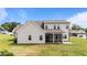 Back of the home with a screened in porch and a concrete patio for outdoor enjoyment at 80 Shallow Falls Ln, Benson, NC 27504