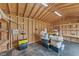 Unfinished interior shed showcasing wood framing, workspace, and shelving for organization at 80 Shallow Falls Ln, Benson, NC 27504