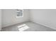 An empty bedroom features neutral carpet and gray paint, offering a serene and adaptable living space at 800 Hillfarm Dr, Wake Forest, NC 27587