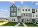 Charming townhome showcasing a beautifully landscaped lawn, inviting entrance, and stylish multi-tone exterior at 800 Hillfarm Dr, Wake Forest, NC 27587
