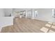 Expansive open-concept living space with wood flooring and neutral walls offering versatility and modern appeal at 800 Hillfarm Dr, Wake Forest, NC 27587