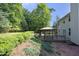 A private backyard features a gazebo, a deck, and mature landscaping in a park-like setting at 803 High Ct, Hillsborough, NC 27278