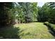 A spacious backyard with a lush lawn and privacy fencing offers a great area for recreation at 803 High Ct, Hillsborough, NC 27278