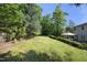 A lovely manicured backyard with mature trees and landscaping provides a private outdoor living space at 803 High Ct, Hillsborough, NC 27278