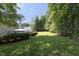 A beautiful backyard with mature trees, a gazebo, and privacy fencing, offers a tranquil retreat at 803 High Ct, Hillsborough, NC 27278
