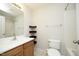 This bathroom features a tub/shower combo, a sink with wood cabinets, and corner shelves at 803 High Ct, Hillsborough, NC 27278