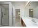 Well-lit bathroom boasts a double vanity and glass shower, ideal for modern living at 803 High Ct, Hillsborough, NC 27278