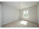 This bedroom features neutral carpet and window at 803 High Ct, Hillsborough, NC 27278