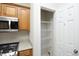 Kitchen featuring microwave, stove, and shelving unit at 803 High Ct, Hillsborough, NC 27278