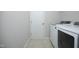 Laundry room with modern washer and dryer and tile flooring at 803 High Ct, Hillsborough, NC 27278