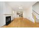 Bright living room with fireplace flows into open kitchen with stainless steel appliances at 803 High Ct, Hillsborough, NC 27278