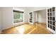 Sunlit living room featuring hardwood floors and decorative glass doors at 803 High Ct, Hillsborough, NC 27278