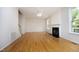 Spacious living room boasts hardwood floors and a cozy fireplace, great for entertaining at 803 High Ct, Hillsborough, NC 27278