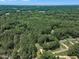 An aerial view shows a lush neighborhood with mature trees and the city skyline in the distance at 804 Colonial Dr, Raleigh, NC 27603