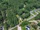Aerial view of a wooded neighborhood with winding roads and well-maintained homes at 804 Colonial Dr, Raleigh, NC 27603