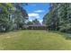 Expansive backyard with lush lawn and brick ranch-style home at 804 Colonial Dr, Raleigh, NC 27603
